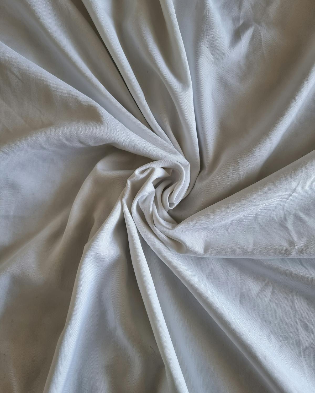 Soft white cotton fabric — the foundation of every Viswak garment